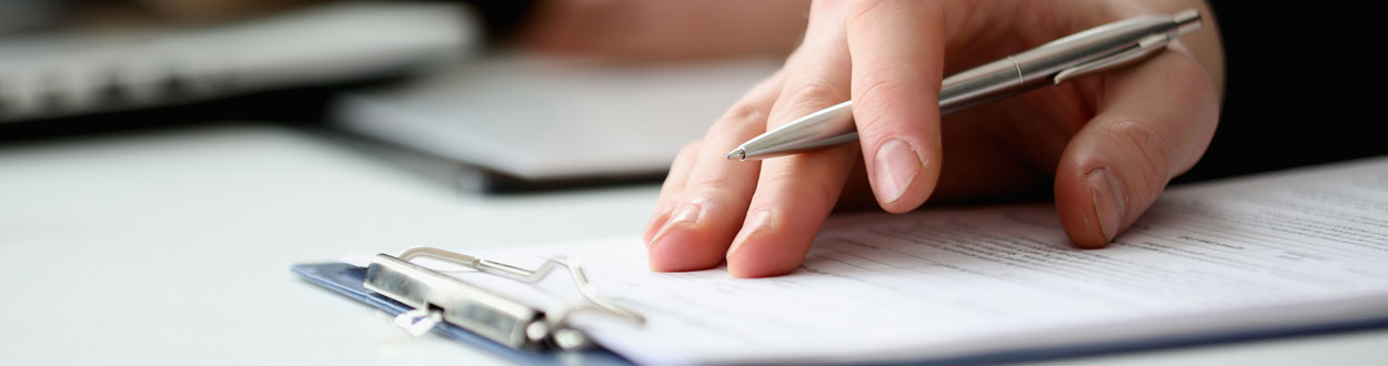 Guarantee Header photo of a hand holding a pen